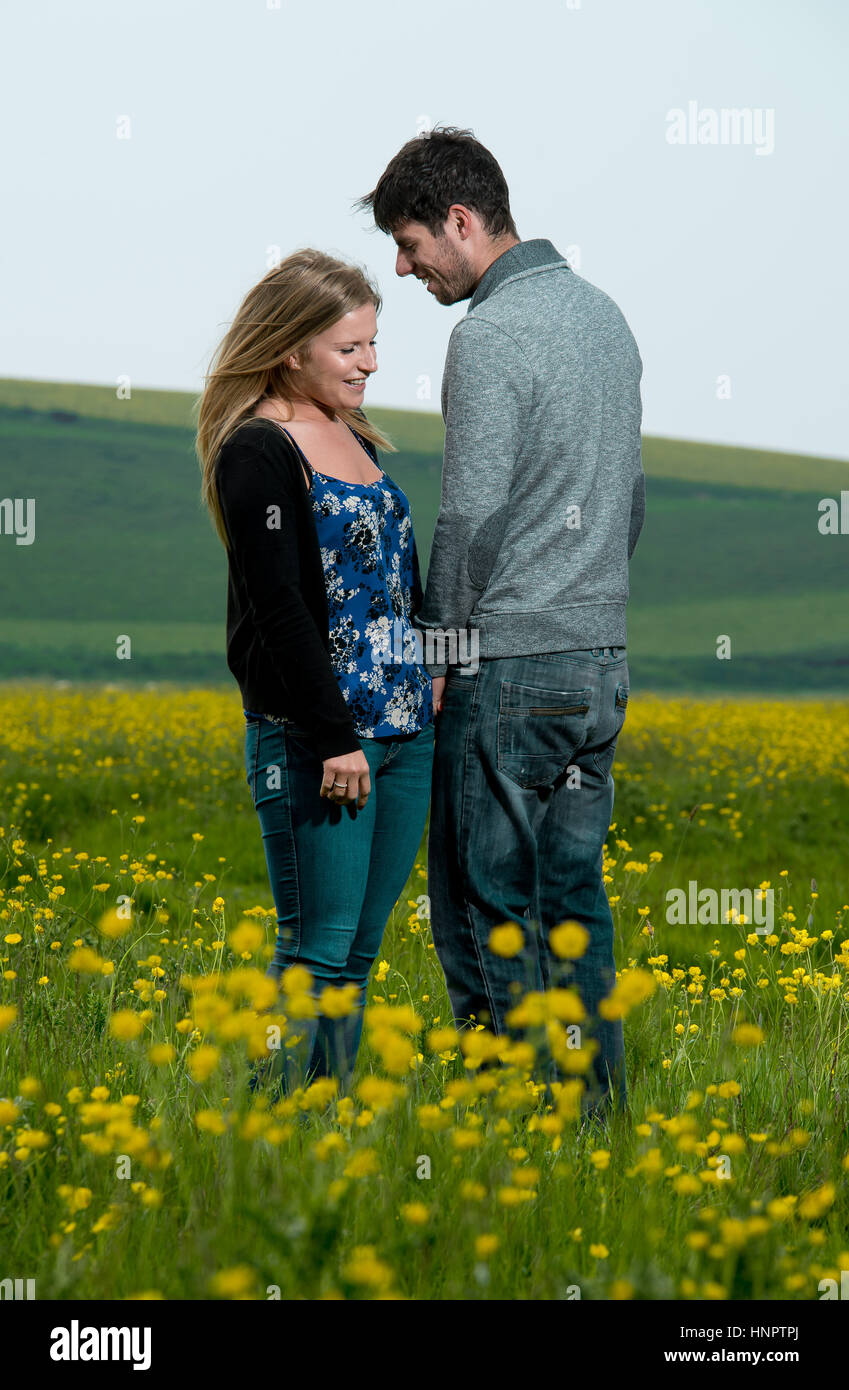 A couple recently engaged show their love for each other near seven sisters, East Sussex, UK. Stock Photo