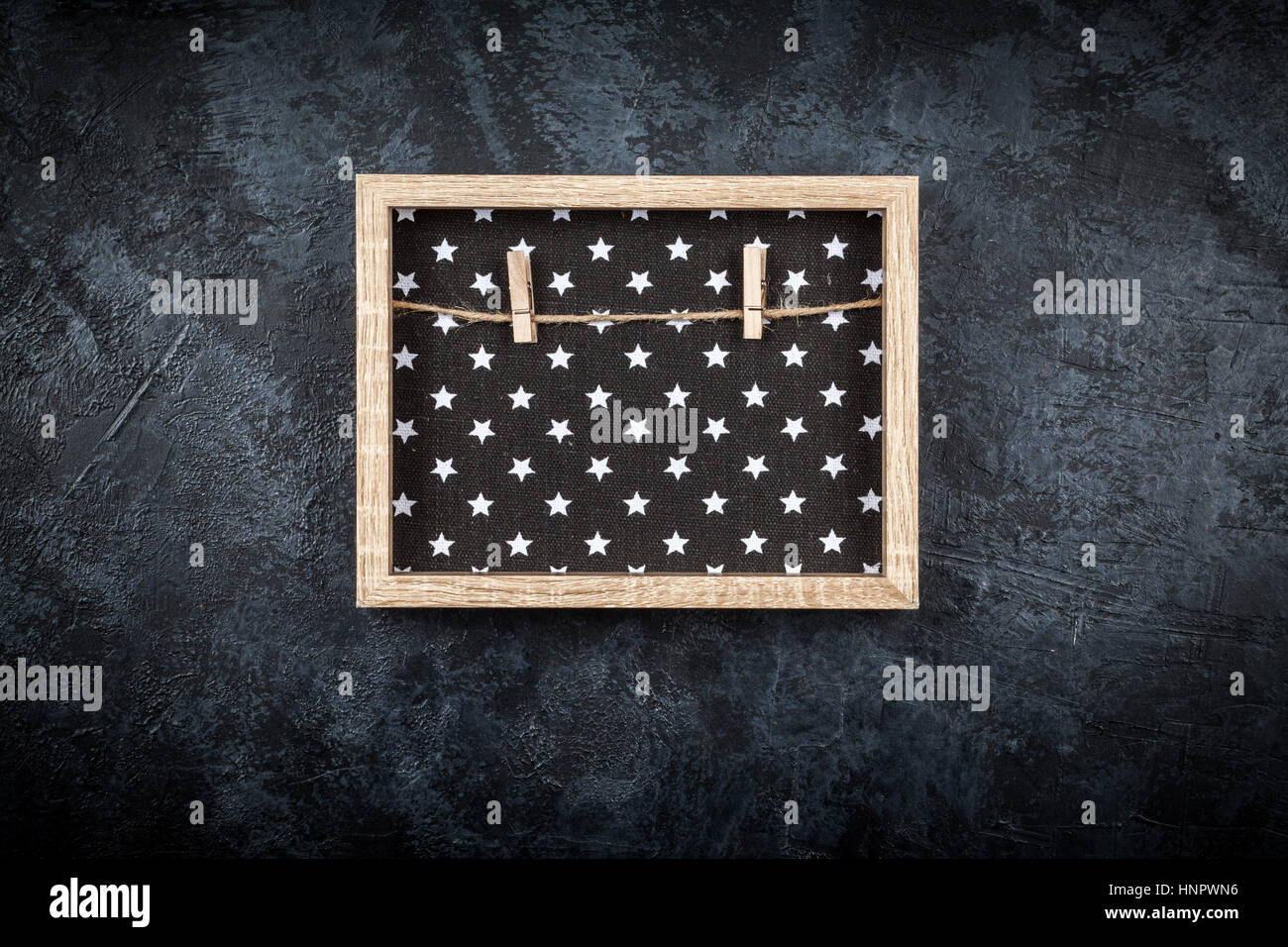Picture frame on a grey wall Stock Photo - Alamy