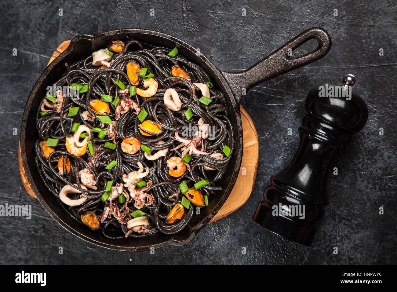 Black spaghetti with seafood Stock Photo - Alamy