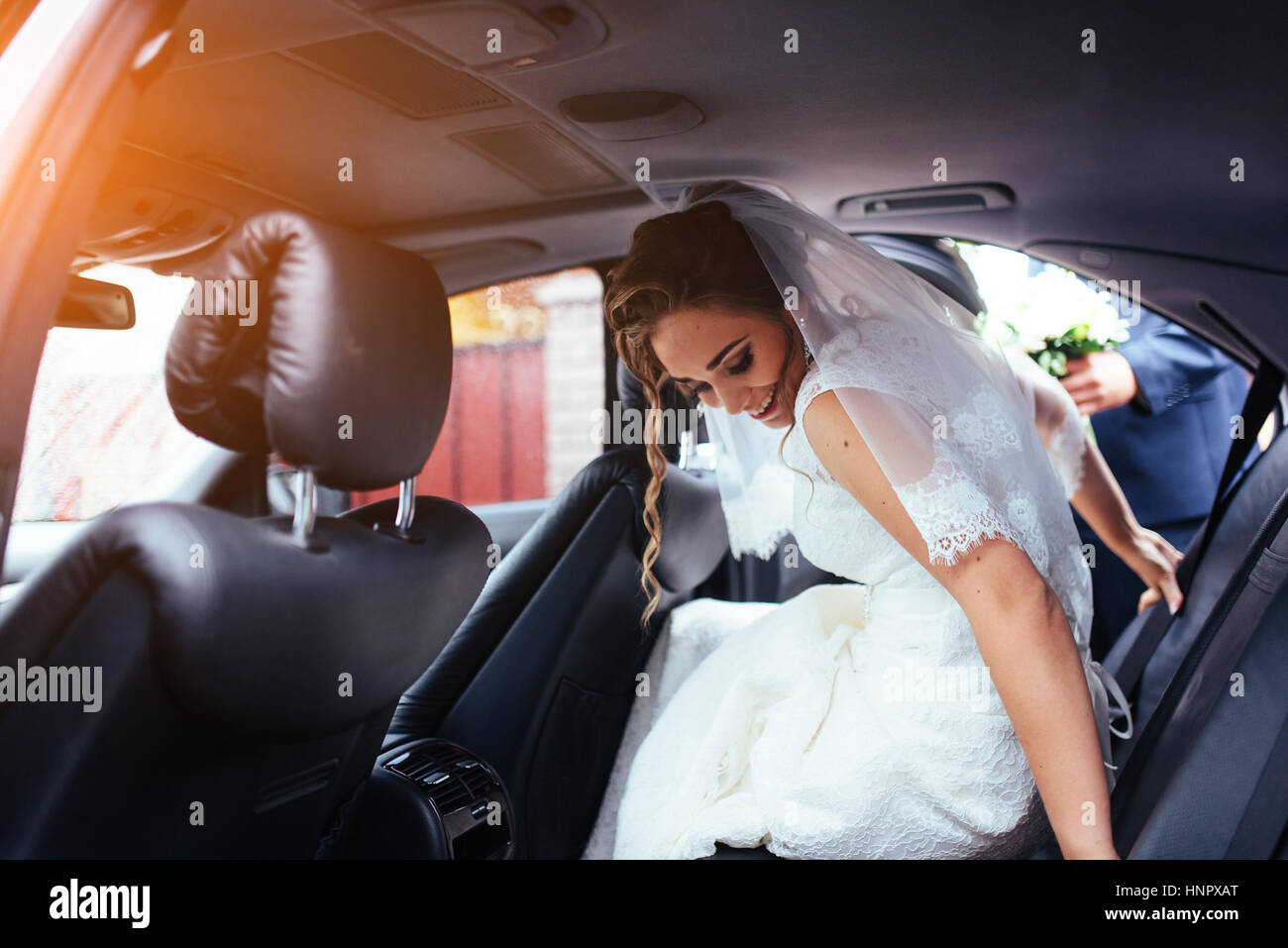 Happy bride and groom near car Stock Photo - Alamy