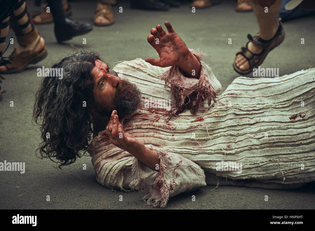 Man plays suffering Jesus Christ, wounded and tortured during the reenactment of the Way of Sorrows on Good Friday, April 15, 2014, Bucharest, Romania Stock Photo