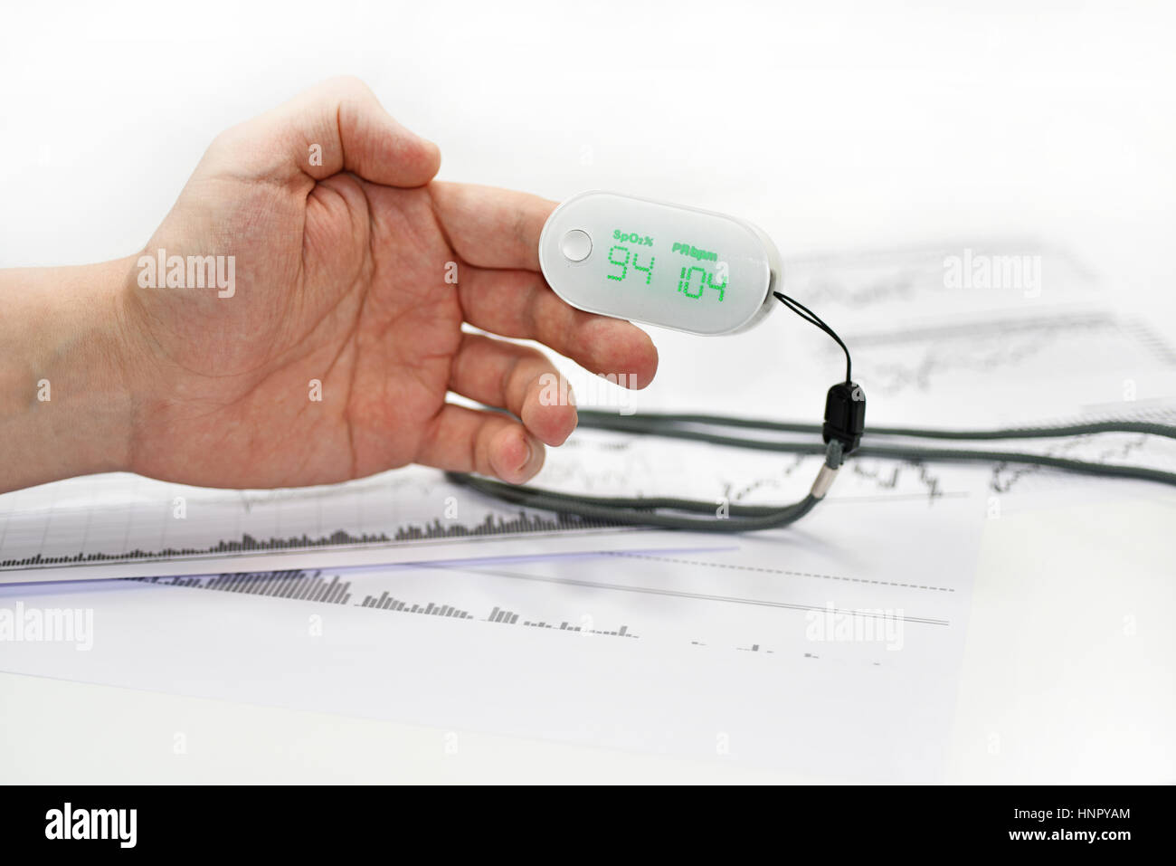 Blood oxygen meter on mans finger Stock Photo Alamy