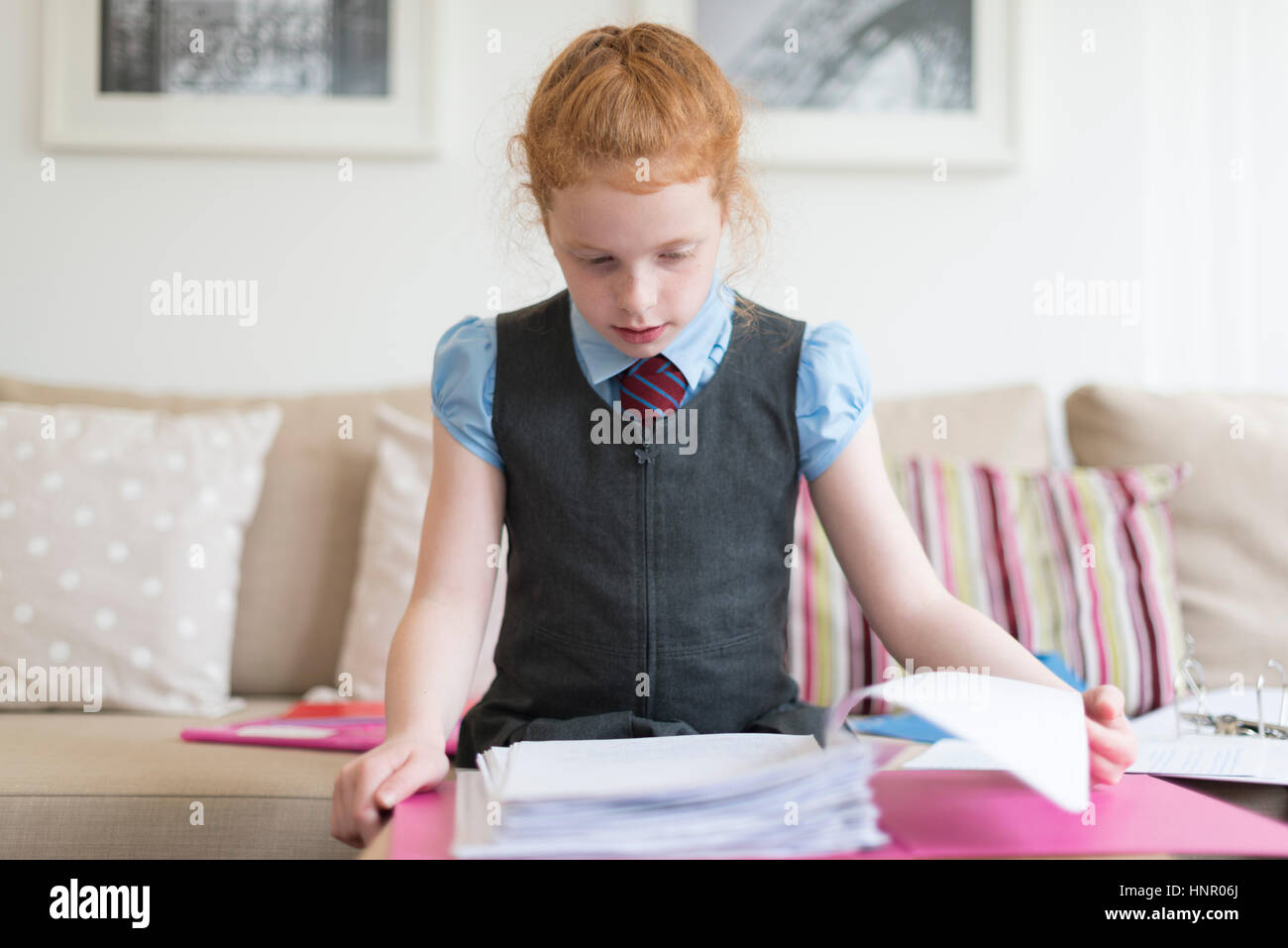 A little girl completing her homework. Stock Photo