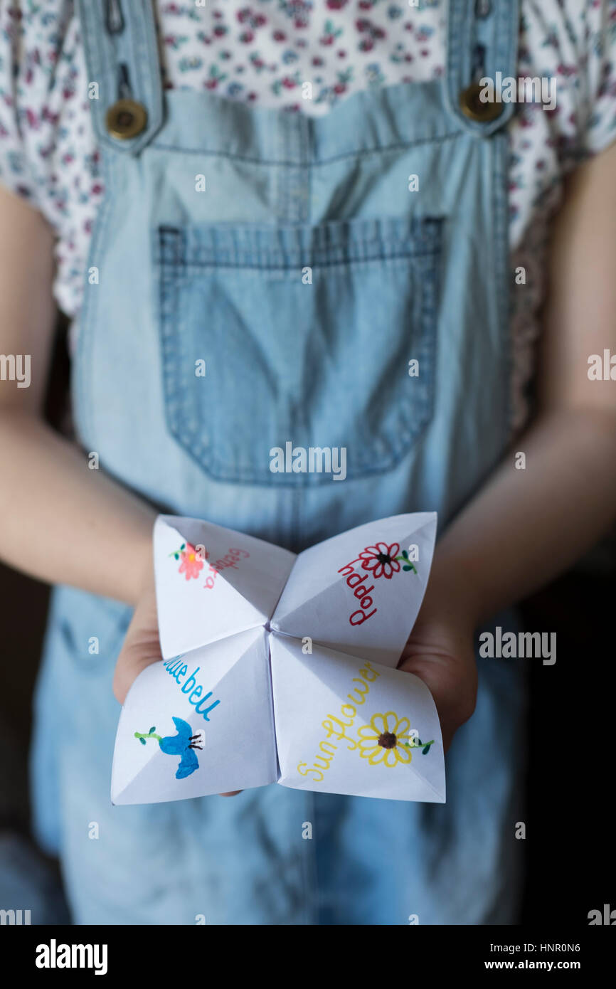 A girl with an Origami Fortune Teller paper game Stock Photo Alamy