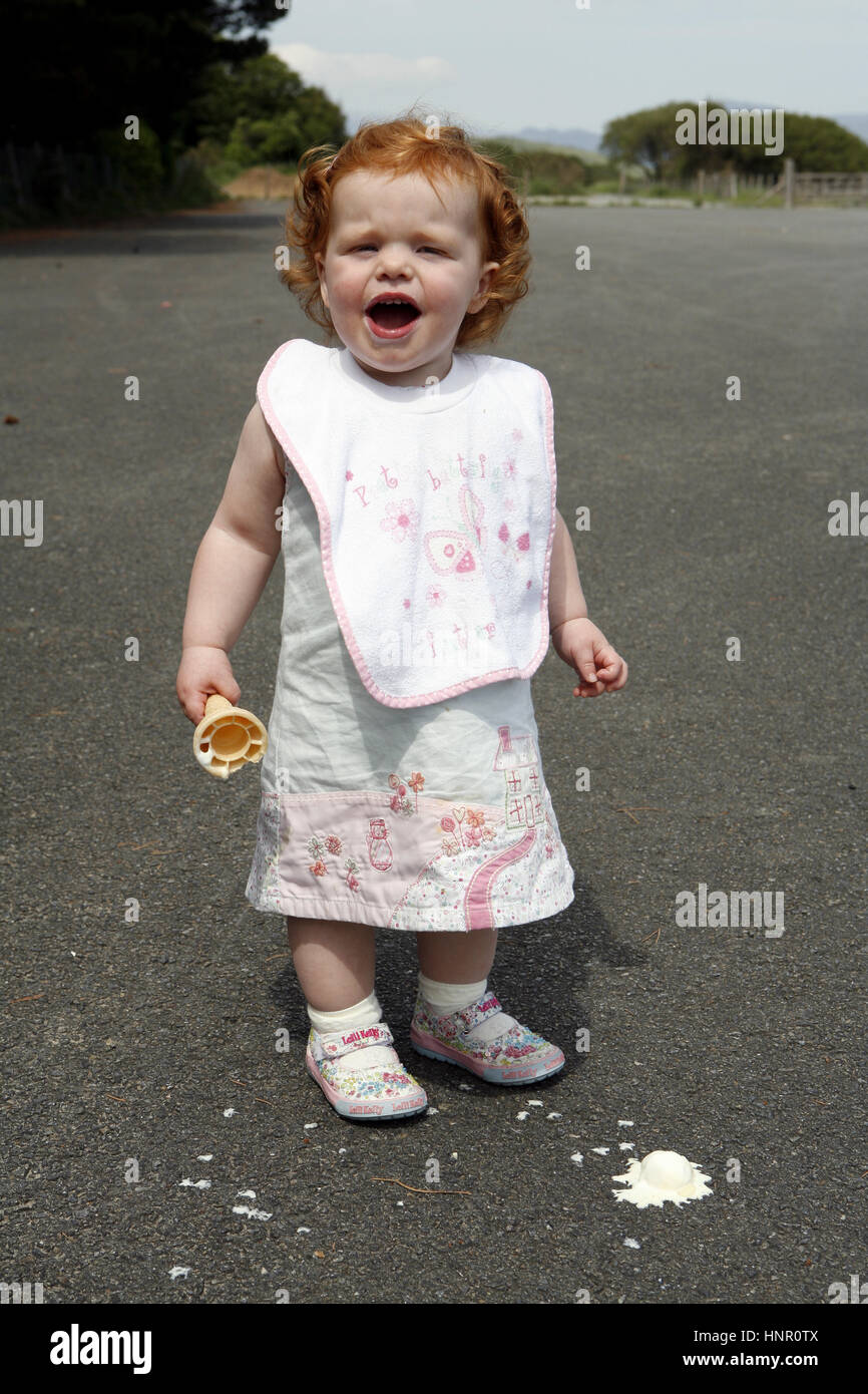 Little girl with her ice cream that has dropped on the floor Stock