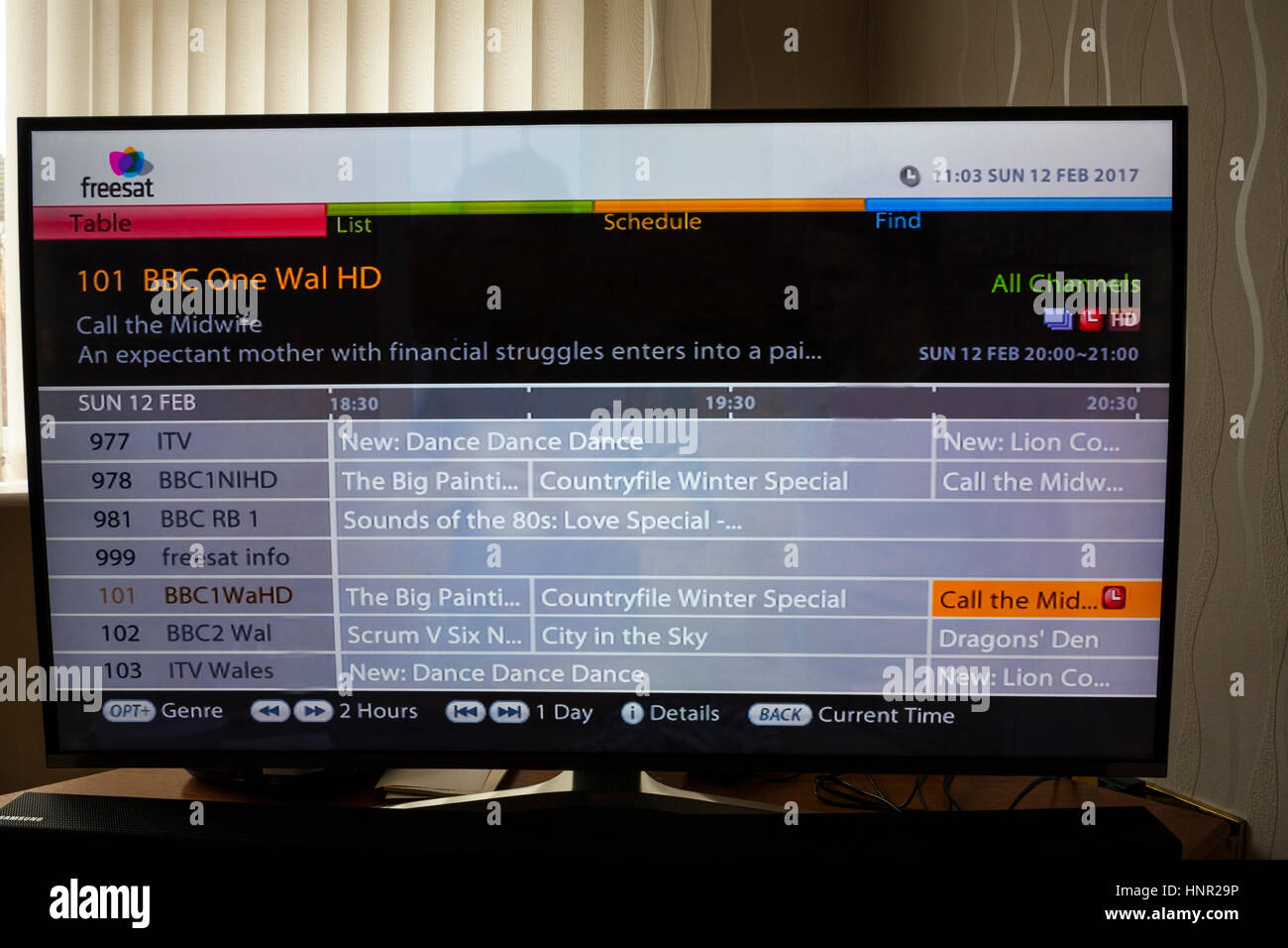 Setting a future programme  recording on a  Freesat Television using the All Channels guide Stock Photo