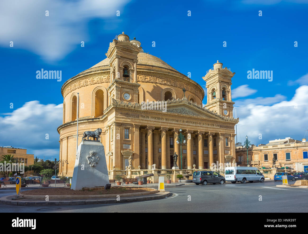 Mosta, Malta - The Church of the Assumption of Our Lady, commonly known as the Rotunda of Mosta or Mosta Dome at daylight with moving clouds and blue  Stock Photo