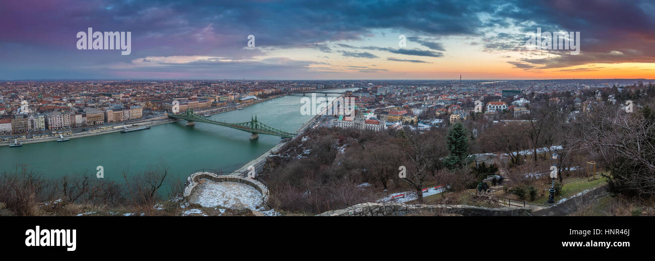 Budapest, Hungary - Panoramic skyline view of the city of Budapest with River Danube, Szabadsag Bridge and Gellert Bath taken from Gellert Hill at sun Stock Photo
