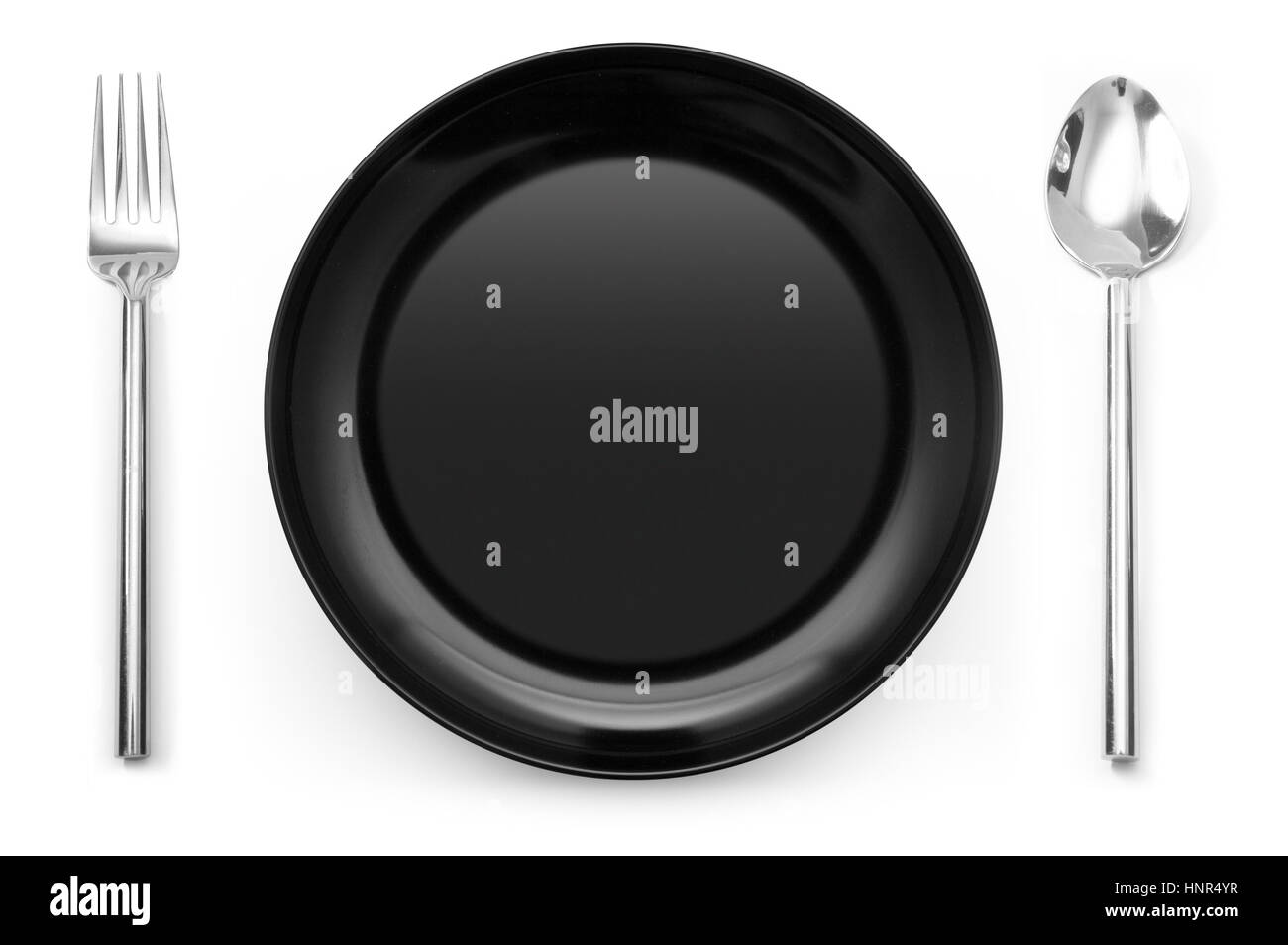 Black place setting with plate fork and spoon on white Stock Photo Alamy