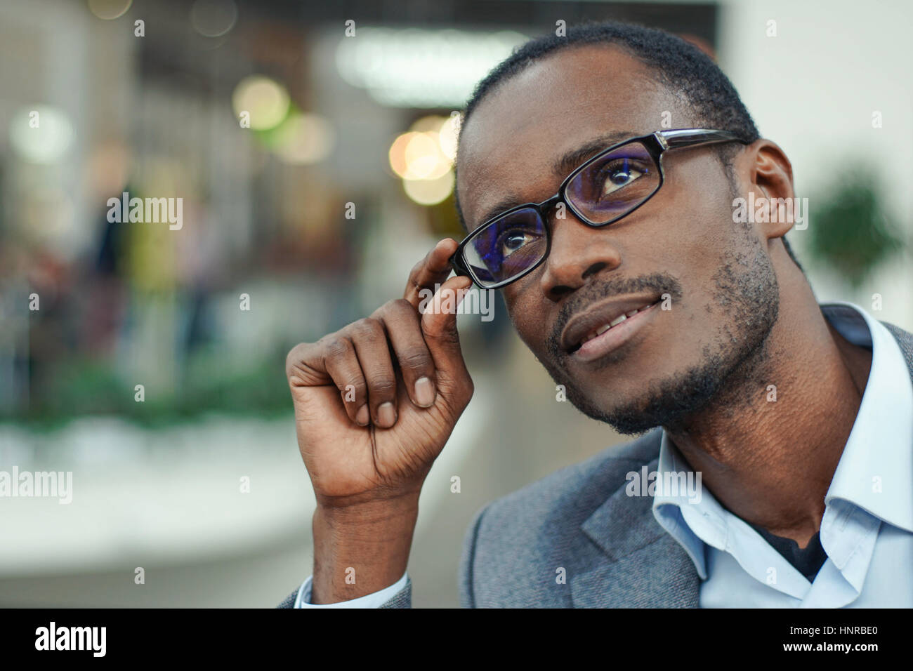 Portrait of handsome afro american man wearing grey suit and glasses ...