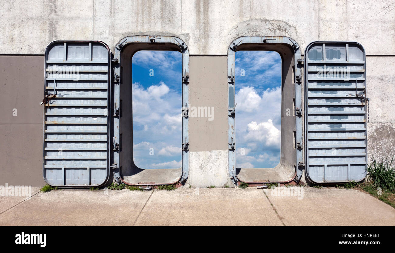 'Watch your step, folks.' Steel and concrete industrial wall and doors o Stock Photo