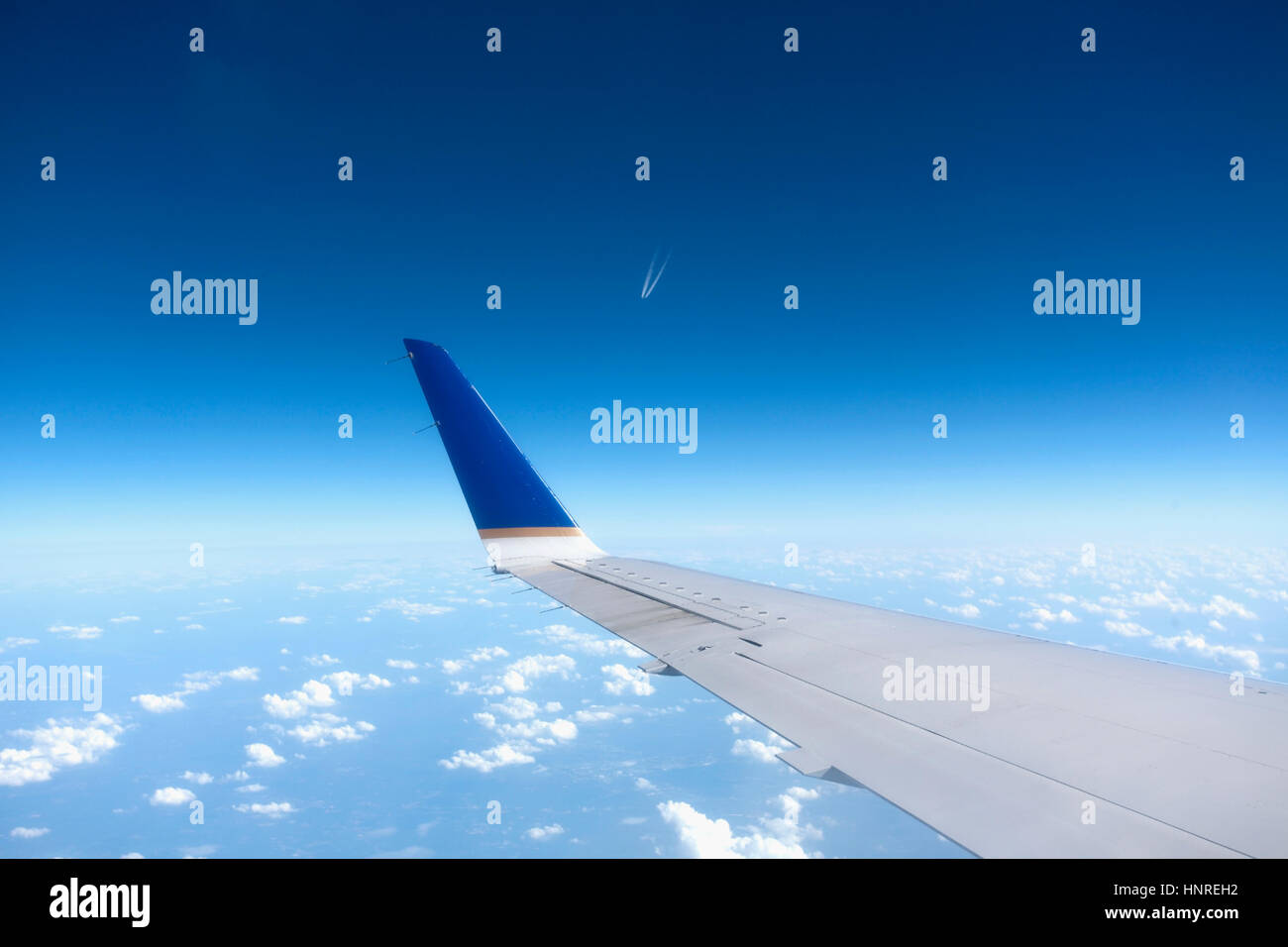 in-flight-airplane-wing-against-clouds-and-blue-sky-stock-photo-alamy