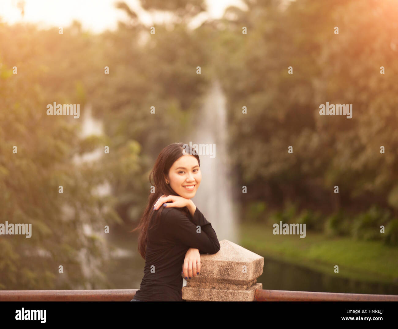 Pretty Thai girl Smiling at the park Stock Photo