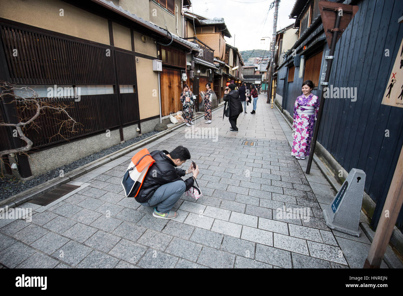 Hanami-koji Street , Kyoto , Japan. A tourist photographs a woman dressed up in fancy dress as a geisha Stock Photo
