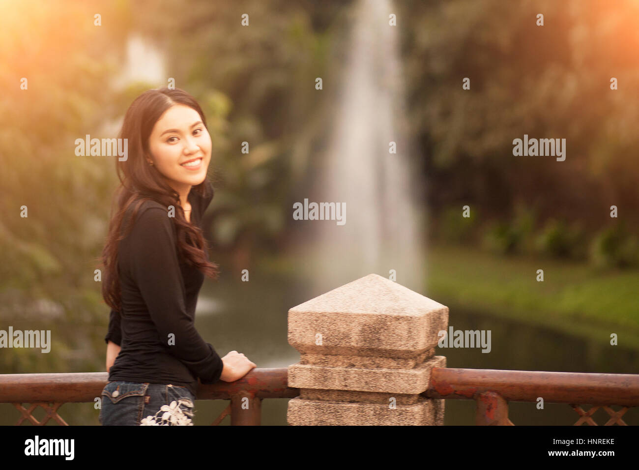 Pretty Thai girl Smiling at the park Stock Photo