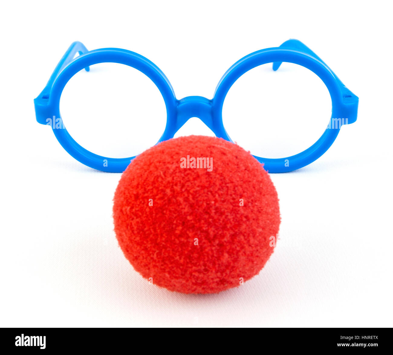 Silly red foam clown nose with goofy glasses. Isolated. Stock Photo