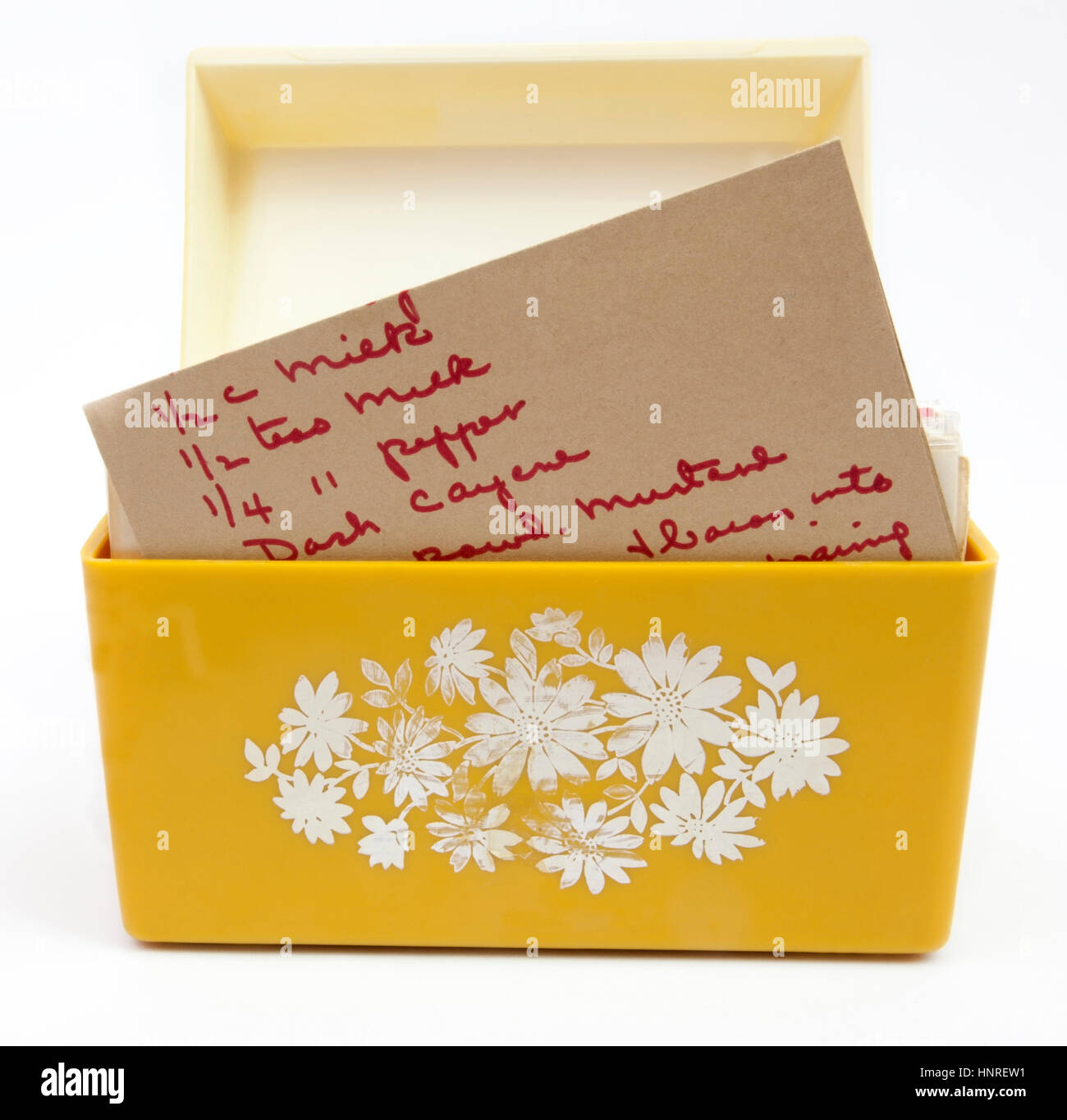 Faded open yellow seventies recipe box with handwritten recipe partially showing. Stock Photo