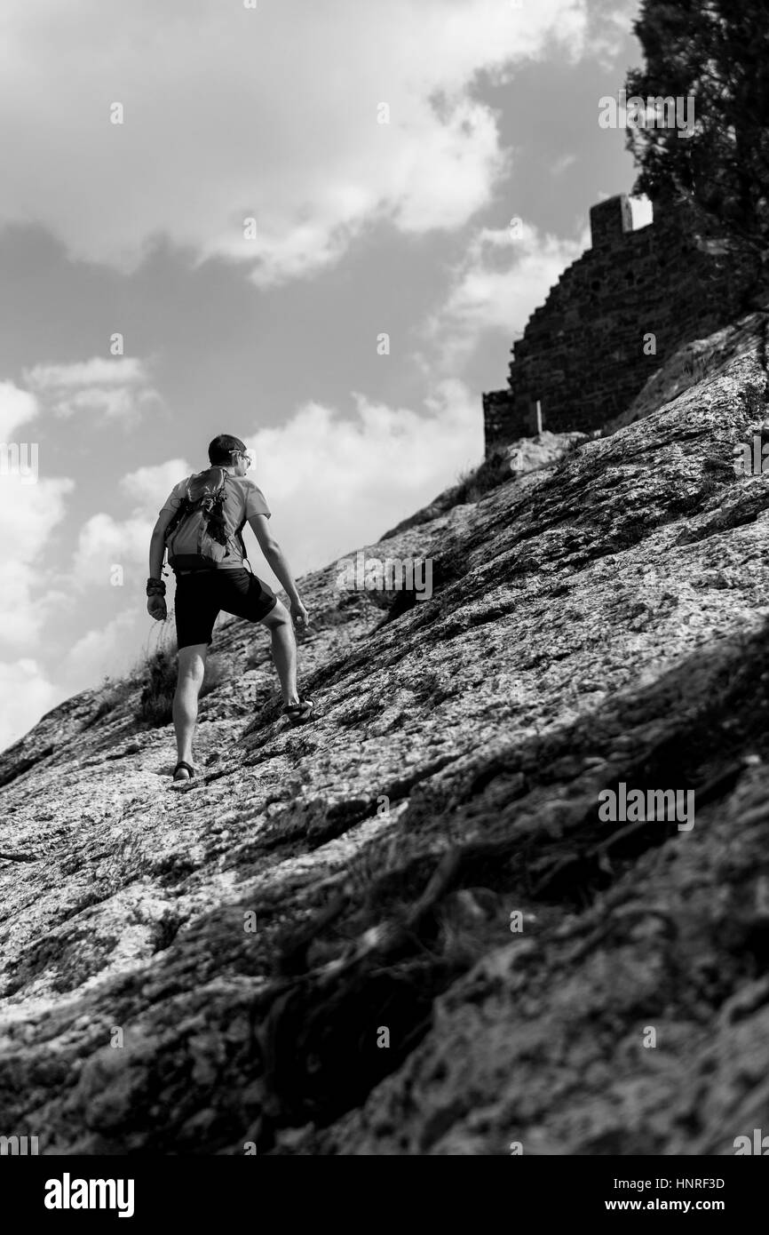 Black and white photo of young man on mountain summer Stock Photo