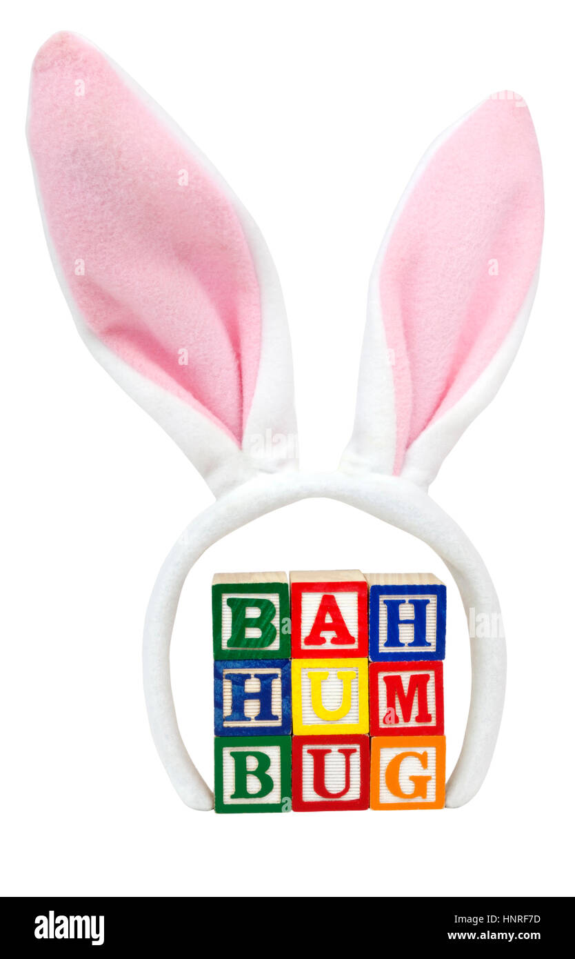 BAH HUMBUG concept presented with toy blocks with pink Easter bunny ears. Stock Photo