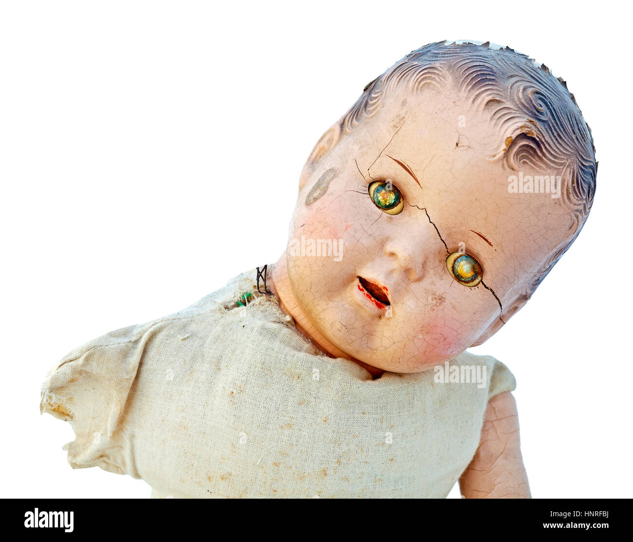 Dilapidated child's doll with scary zombie-likw expression. Stock Photo