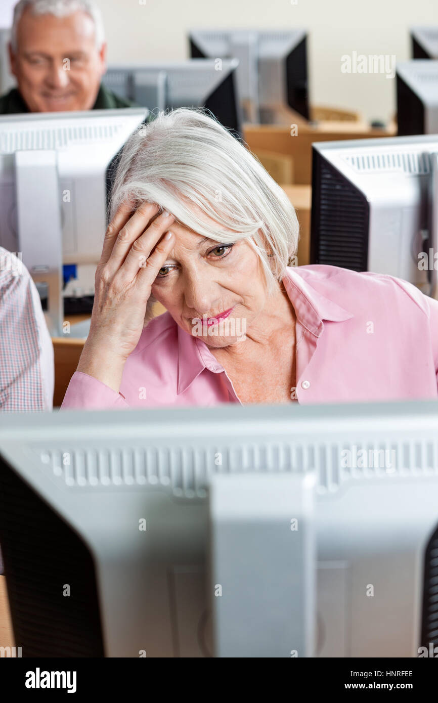 Tensed Senior Student Looking At Computer Stock Photo