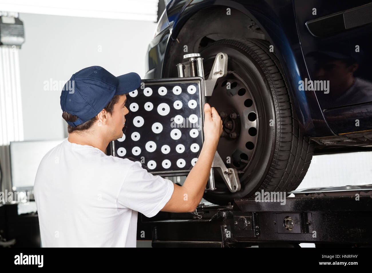 Male Mechanic Adjusting Wheel Alignment Machine Stock Photo Alamy