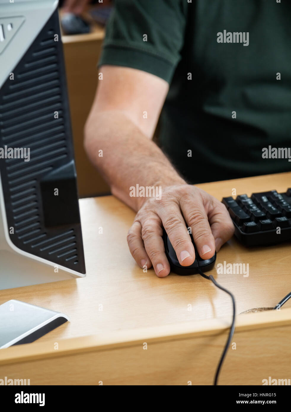 Midsection Of Senior Student Using Desktop PC Stock Photo