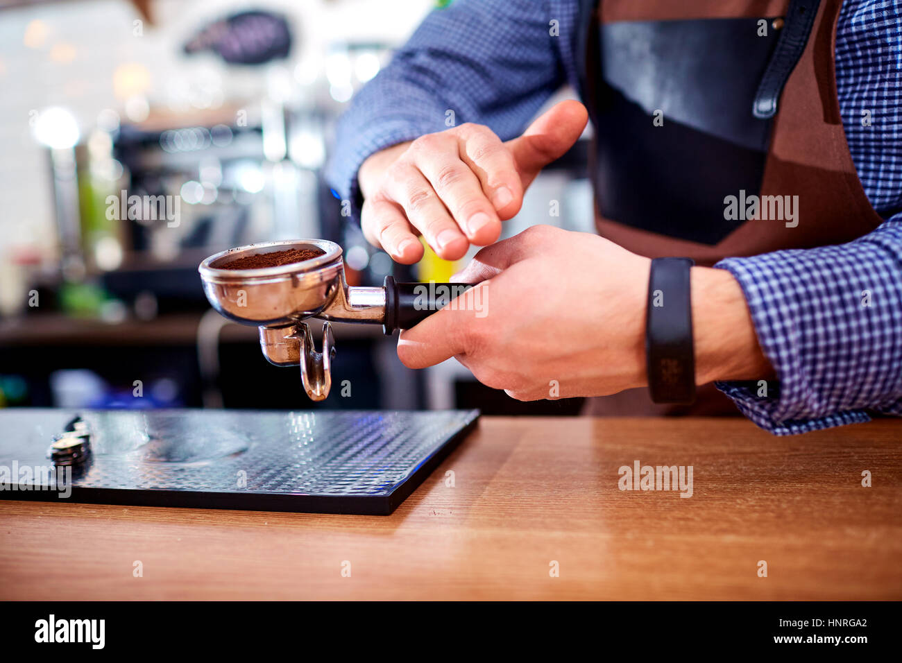 Close-up of hand Barista cafe making coffee with manual presses ground  coffee using a tamper at the coffee shop 27393656 Stock Photo at Vecteezy