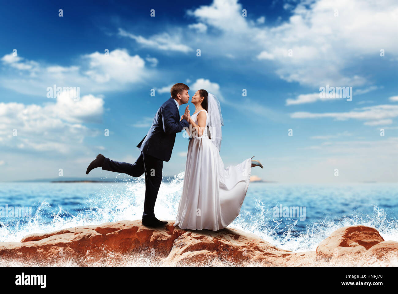 Bride and groom kissing on the sea shore. Romantic honeymoon Stock ...