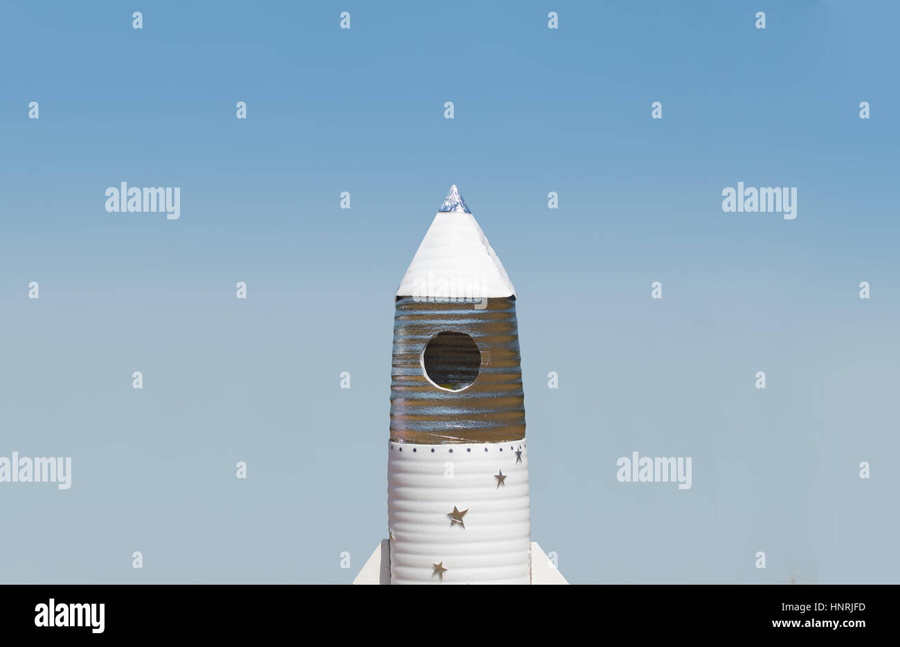 Big hand made toy rocket standing outdoor against sky Stock Photo