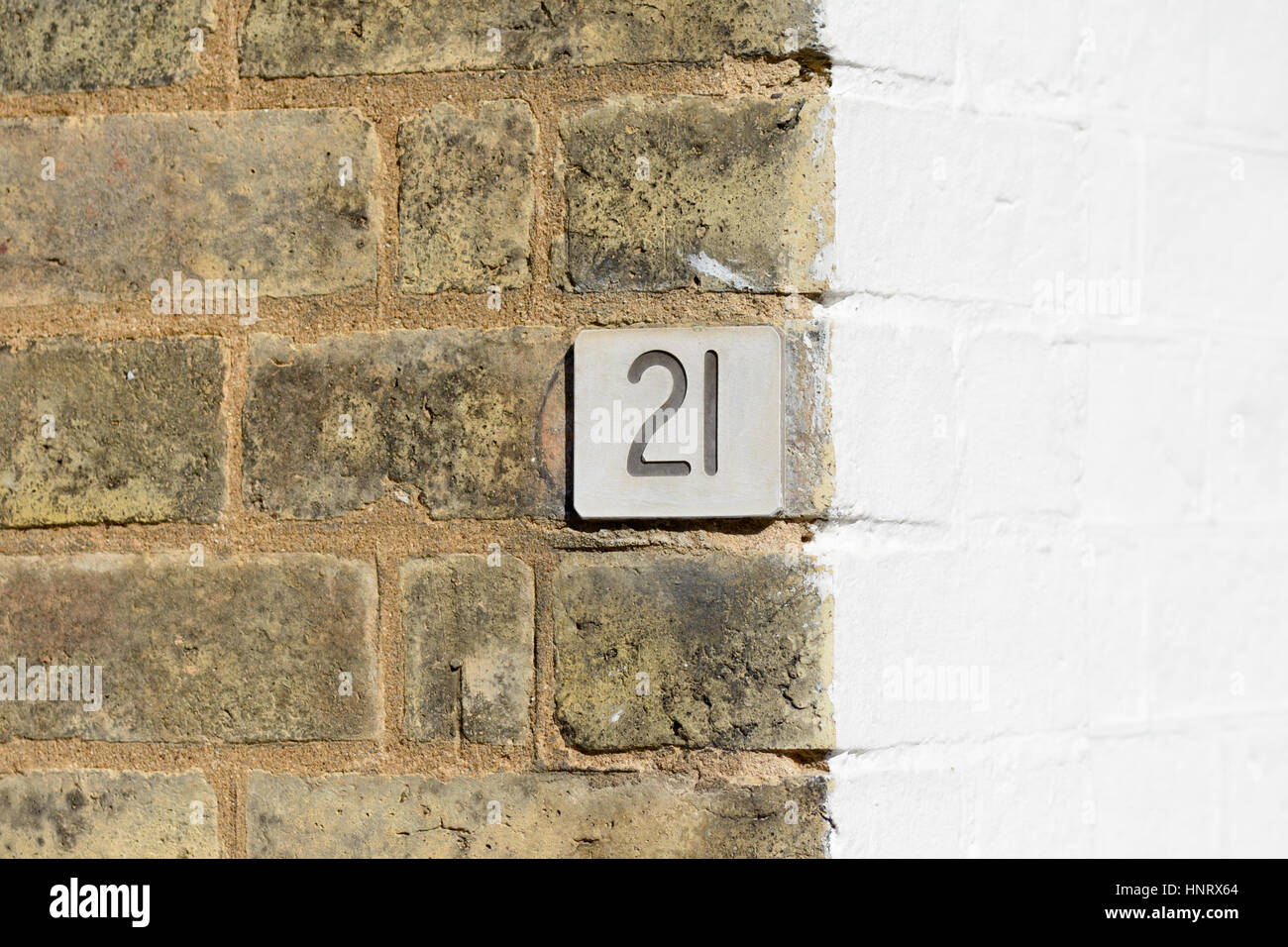 House number 21 sign on wall Stock Photo