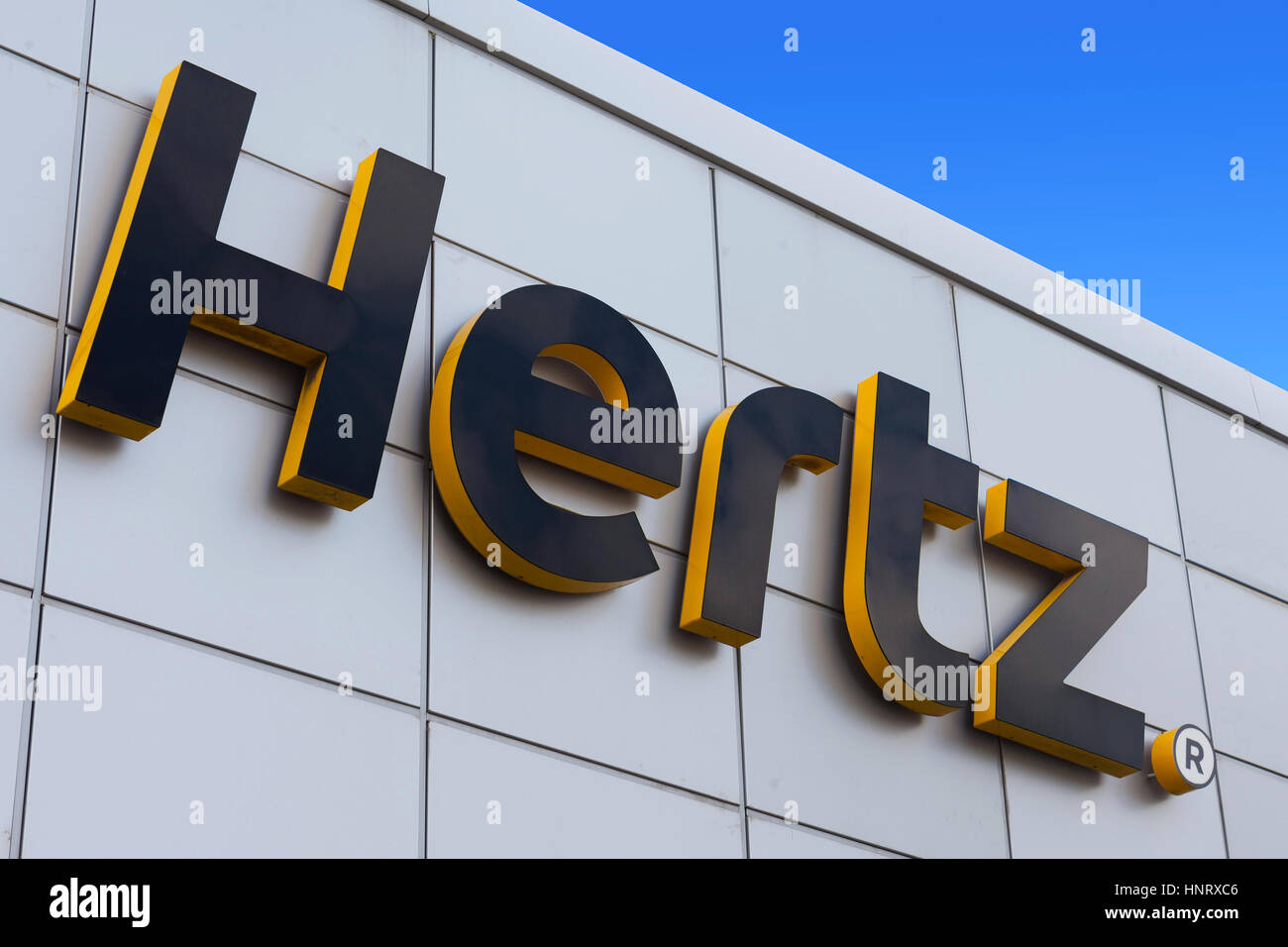 Hertz sign on a building. Hertz is an American car rental company with international locations in 150 countries worldwide. Stock Photo