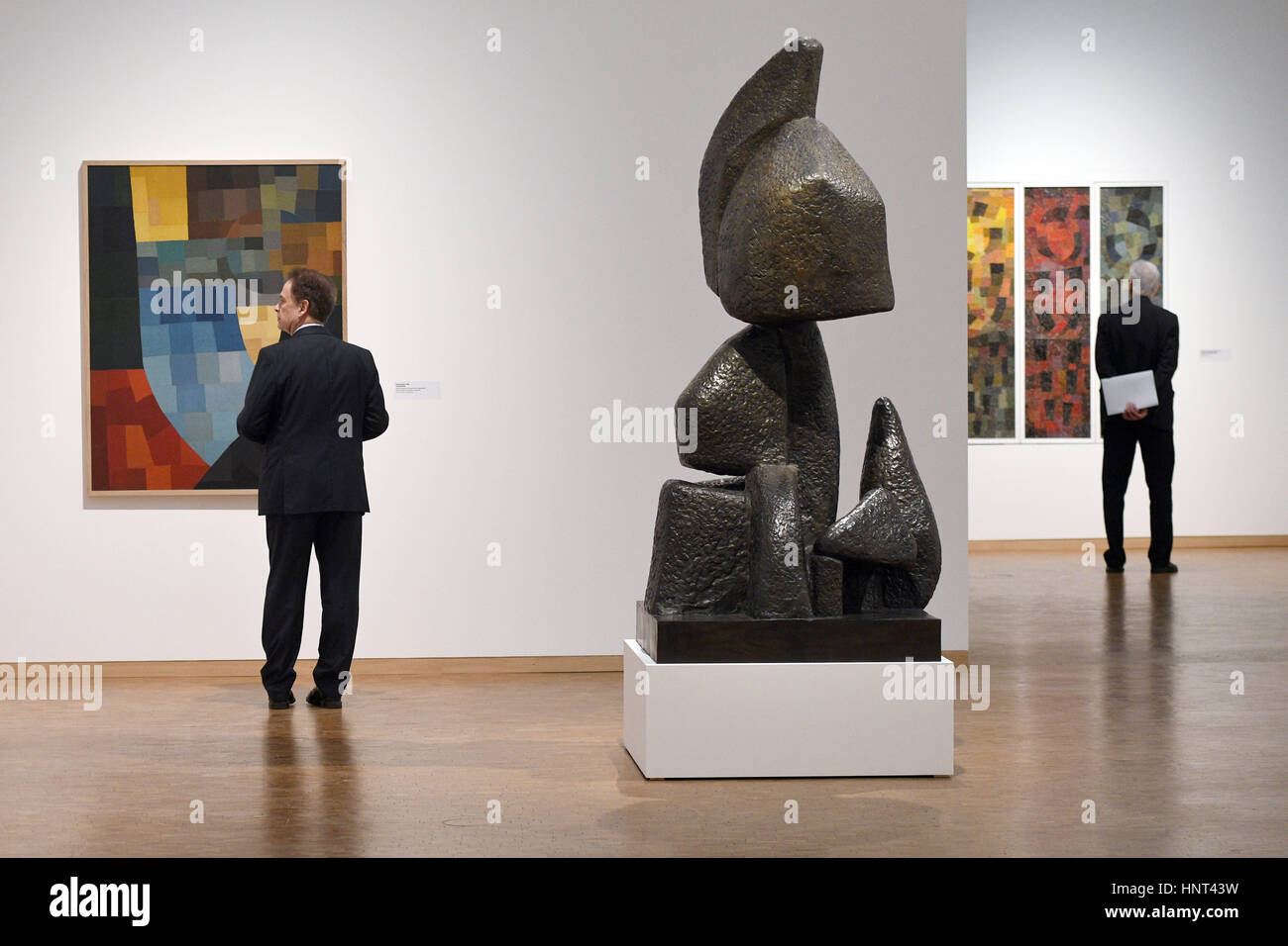 Cologne, Germany. 16th Feb, 2017. L-R: The painting 'Composition' (1930), the bronze sculpture 'Ascent' (1929/1960) and the painting 'Homage to the Coloured Peoples' (1938) by Otto Freundlich on display as part of the Ludwig Museum's 'Otto Freundlich: Cosmic Communism' show in Cologne, Germany, 16 February 2017. Photo: Henning Kaiser/dpa/Alamy Live News Stock Photo