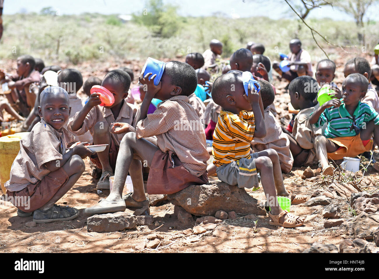 Kajiado, Kenya. 16th February, 2017. Students of the Olomayiana West Primary School enjoy their lunch, porridge cooked with government aid food, at Olomayiana West Primary School in Kajiado County, Kenya, Feb. 15, 2017. The Kenyan government last Friday declared the current drought affecting 23 arid and semi-arid counties and pockets of other areas a national disaster. The UN Food and Agriculture Organization (FAO) have warned that Kenya is facing a severe drought and with it a rise in food insecurity. Credit: Xinhua/Alamy Live News Stock Photo