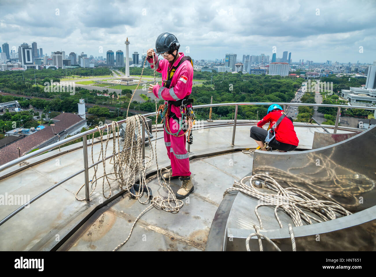 Jakarta, Indonesia. 17th February, 2017. Voluntary workers coils the ropes at the hightest standing platform of the 66.66 metres-height tower of Istiqlal Mosque in Jakarta, Indonesia. Dozens of members of the outdoor activity enthusiasts clubs, rope access companies, and outdoor adventure service organization, gather voluntarily to clean up the largest mosque in Southeast Asia to strengthen the national unity, solidarity, and tolerance. Stock Photo
