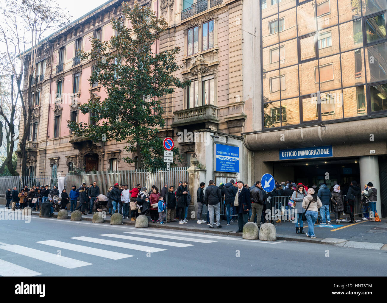 Queue for the Immigration Office in Milan, Italy. Italy is facing a refugee crisis due to ongoing wars in North Africa and the Middle East Stock Photo