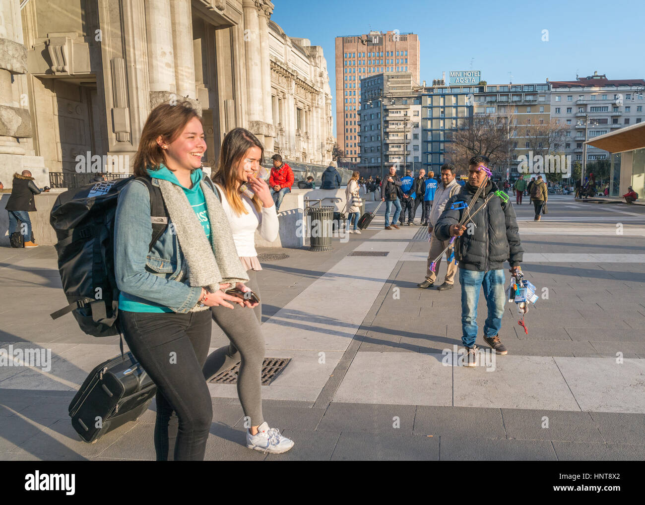 Milan, Italy. 17th Feb, 2017. A street hawker in front of Milan's Central Station advertises electronic goods to recently arrived happy tourists Credit: Alexandre Rotenberg/Alamy Live News Stock Photo