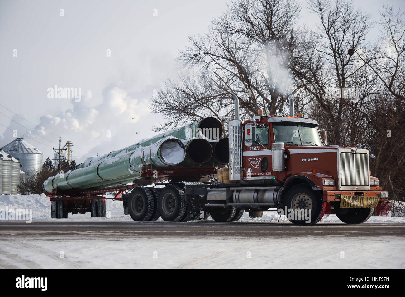 Richardton, North Dakota, USA. 6th Jan, 2017. A truck hauls pipeline used for the Dakota Access Pipeline toward a construction site from a storage facility. Credit: Joel Angel Juarez/zReportage.com/ZUMA Wire/Alamy Live News Stock Photo
