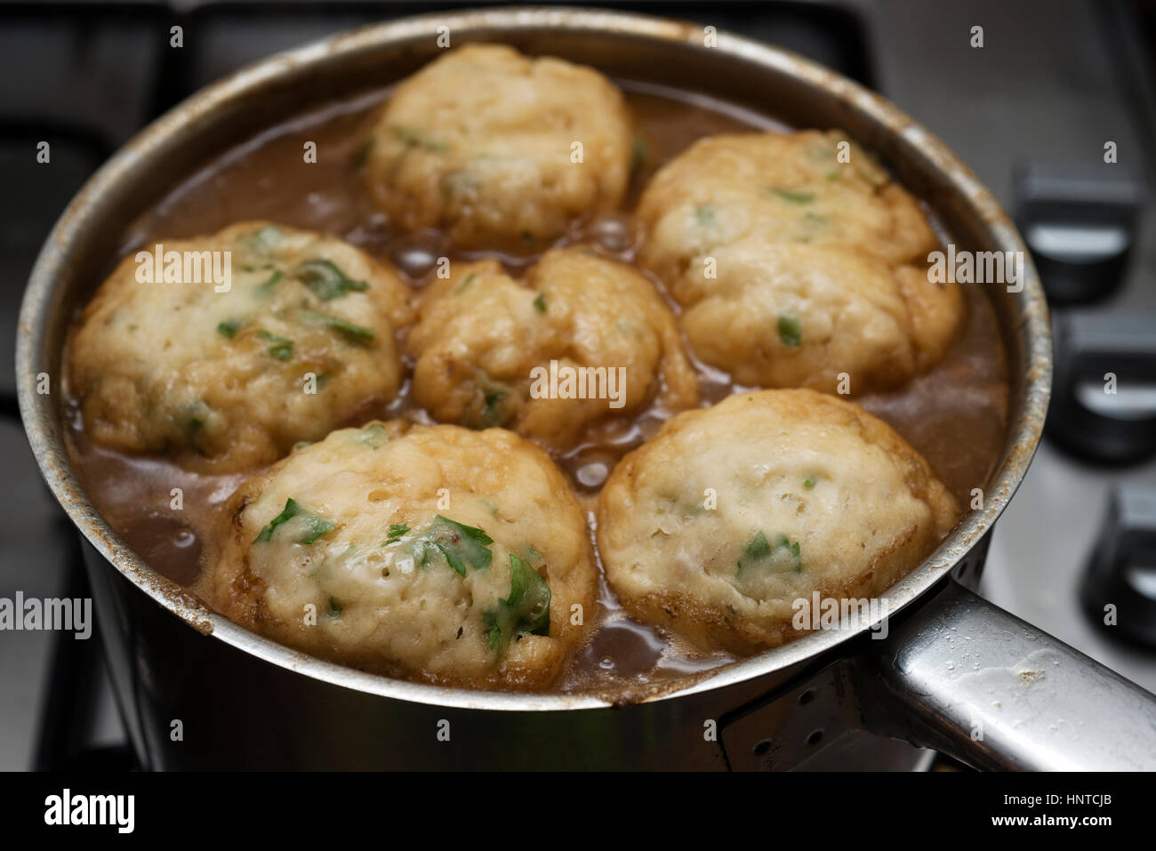 Homemade beef stew with parsley dumplings Stock Photo