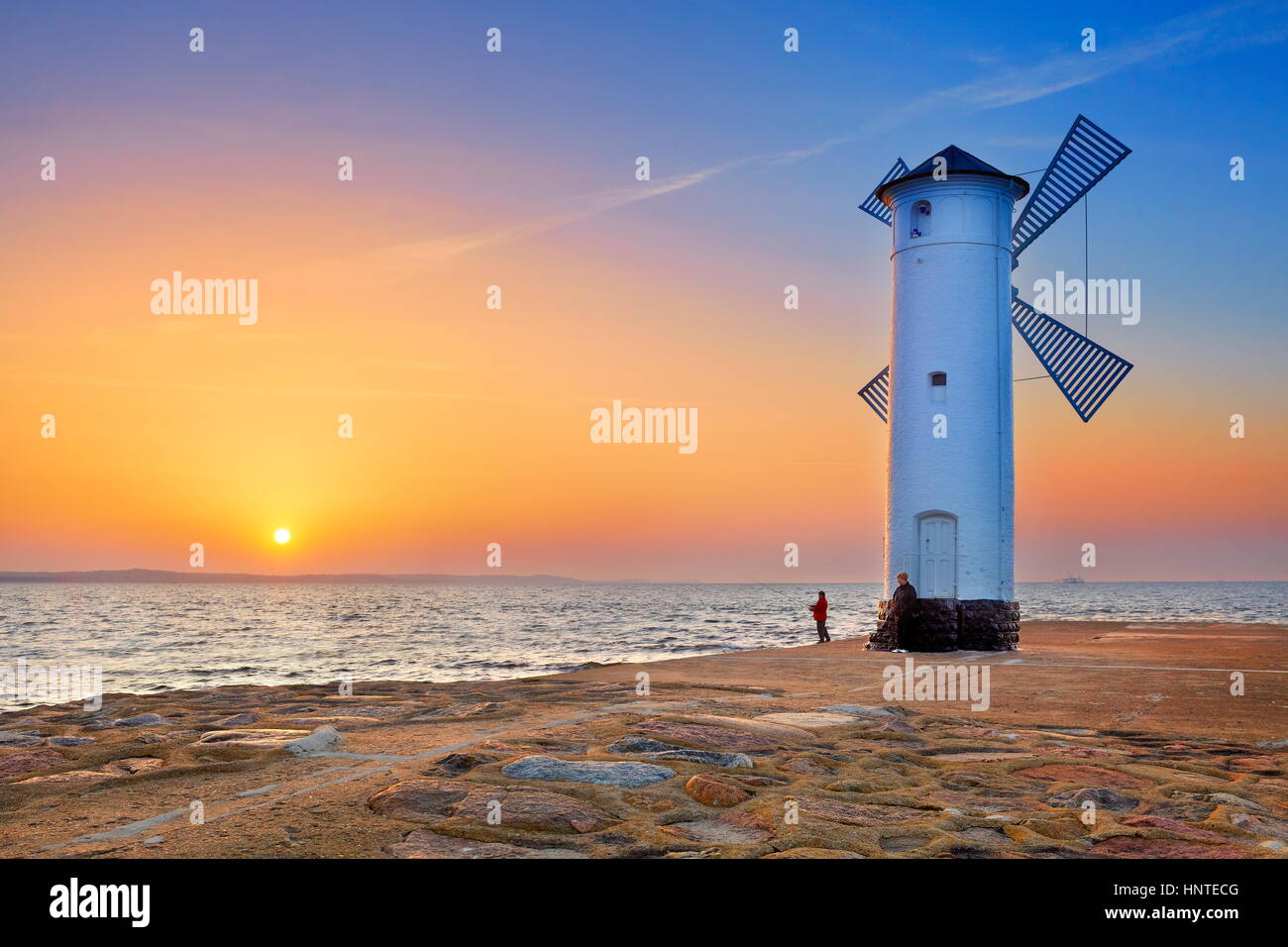 Landscape with Windmill, Swinoujscie, Baltic Sea at sunset, Pomerania, Poland Stock Photo