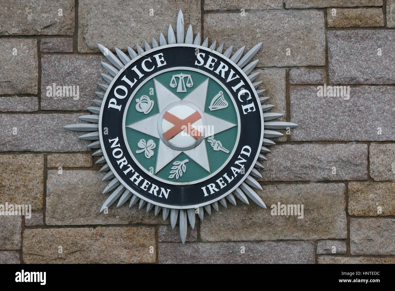 Large PSNI badge on the outer wall of the police station in Newcastle, County Down, Northern Ireland.(Badge Police Service of Northern Ireland). Stock Photo