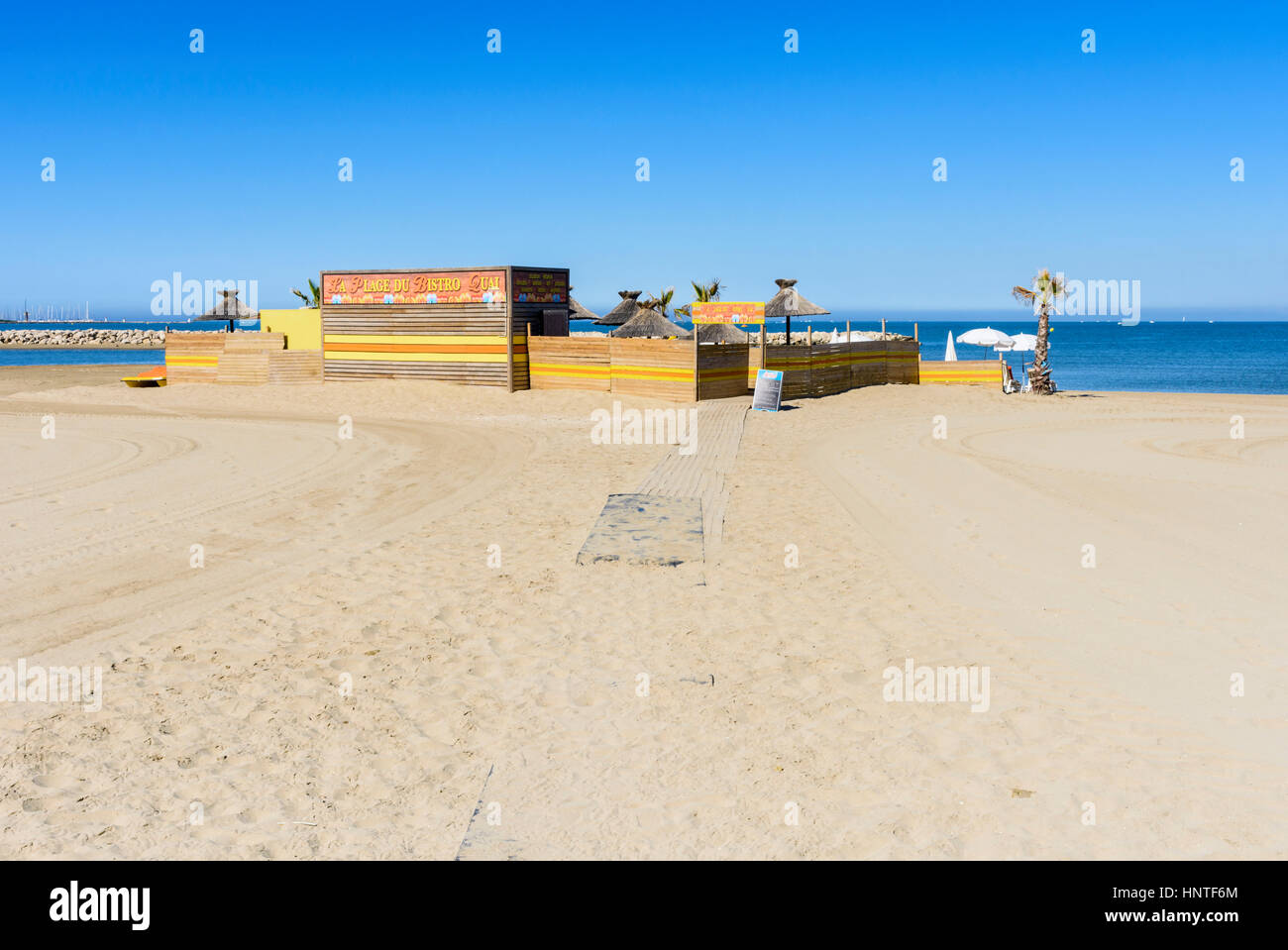 Sandy path leading to a beach cafe on Plage Rive Gauche, Le Grau-du-Roi, Gard, France Stock Photo