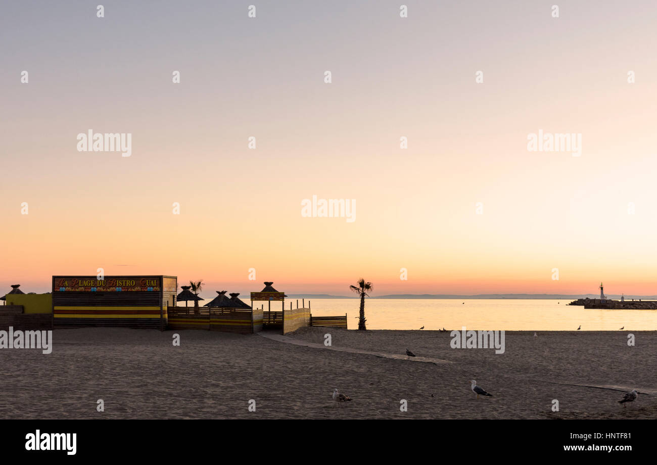 Sunset over a beach cafe on Plage Rive Gauche, Le Grau-du-Roi, Gard, France Stock Photo