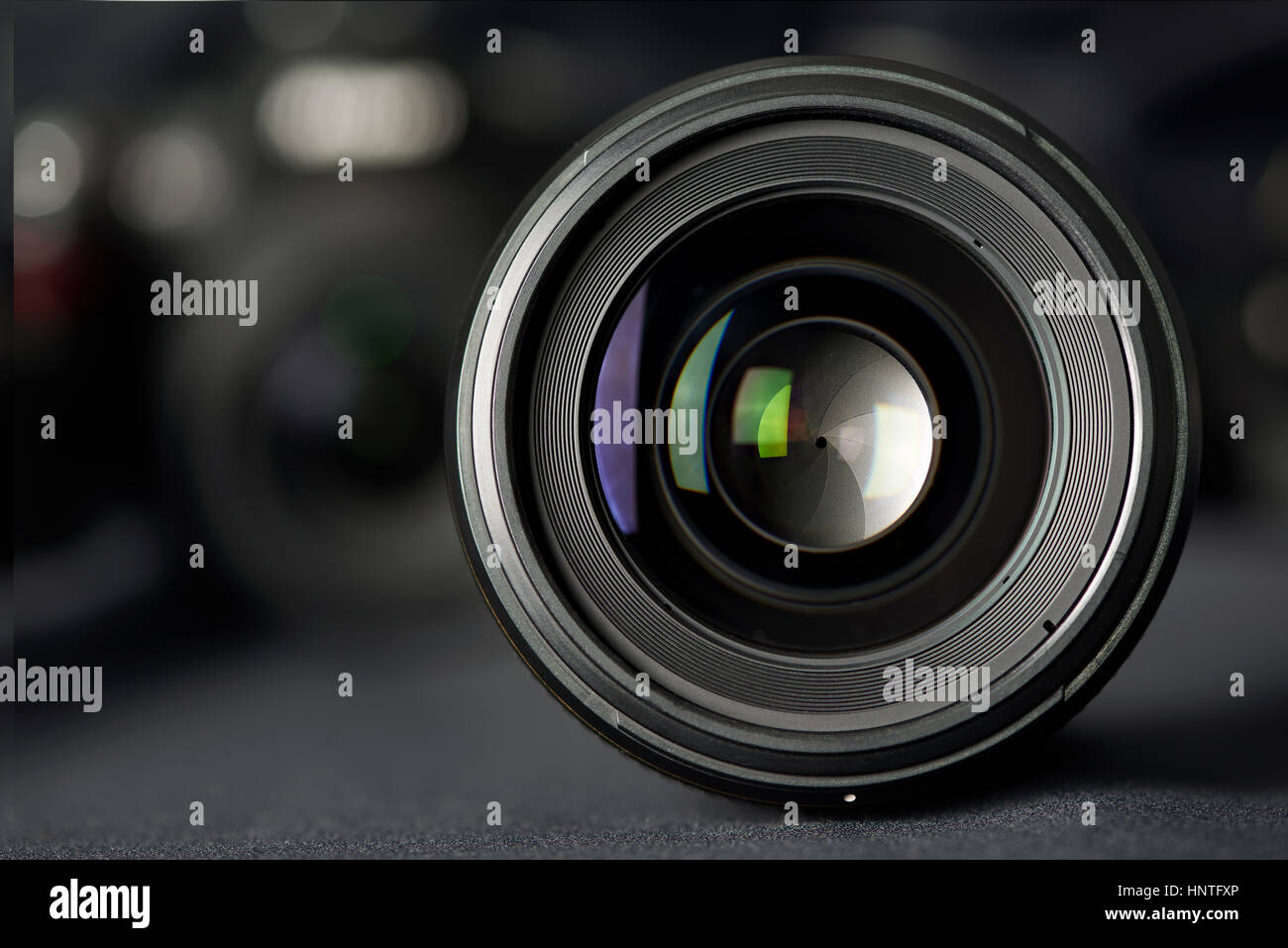 Photo lens front view on blurred camera background Stock Photo Alamy