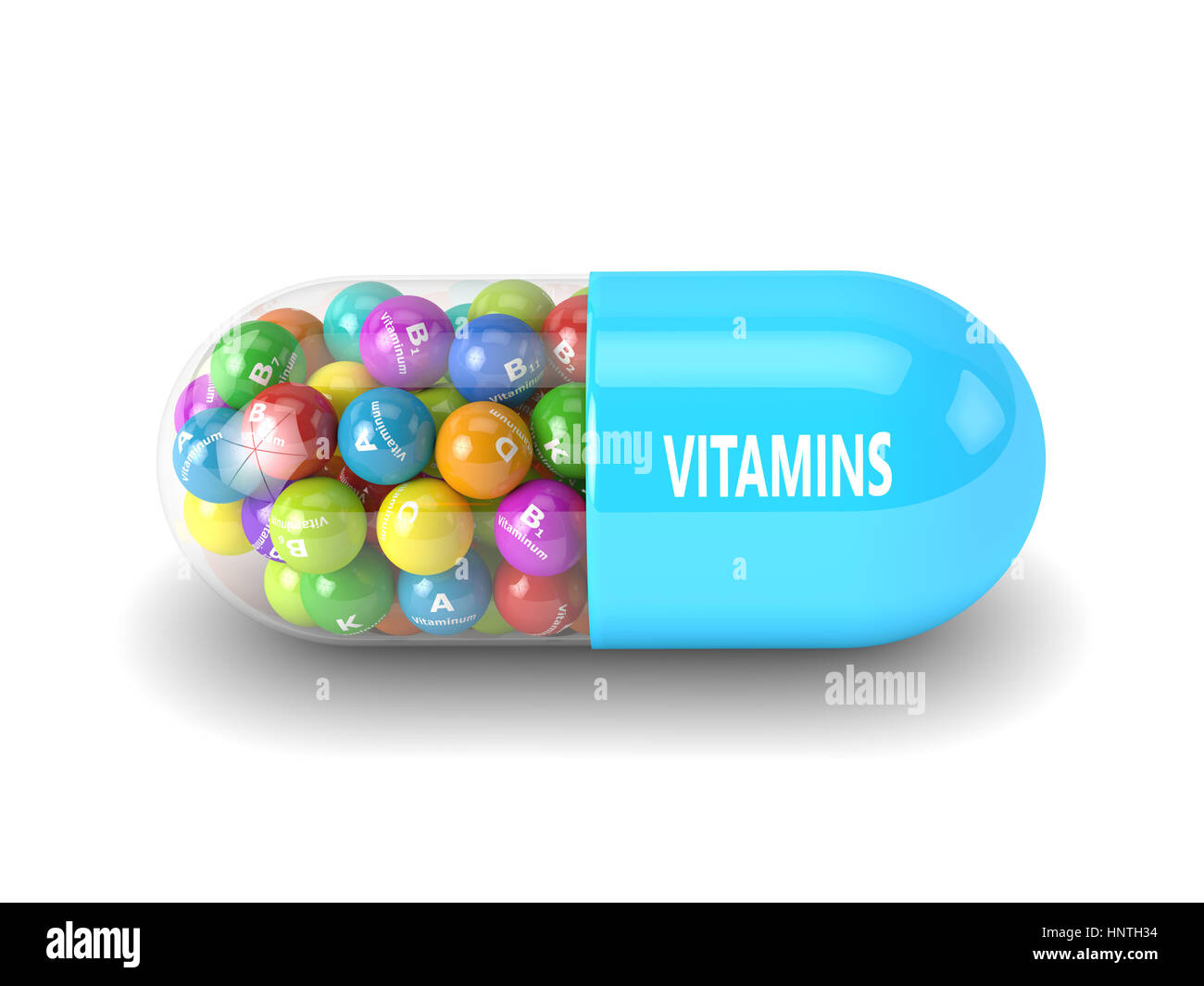 3d rendering of vitamin pill with granules over white background Stock Photo