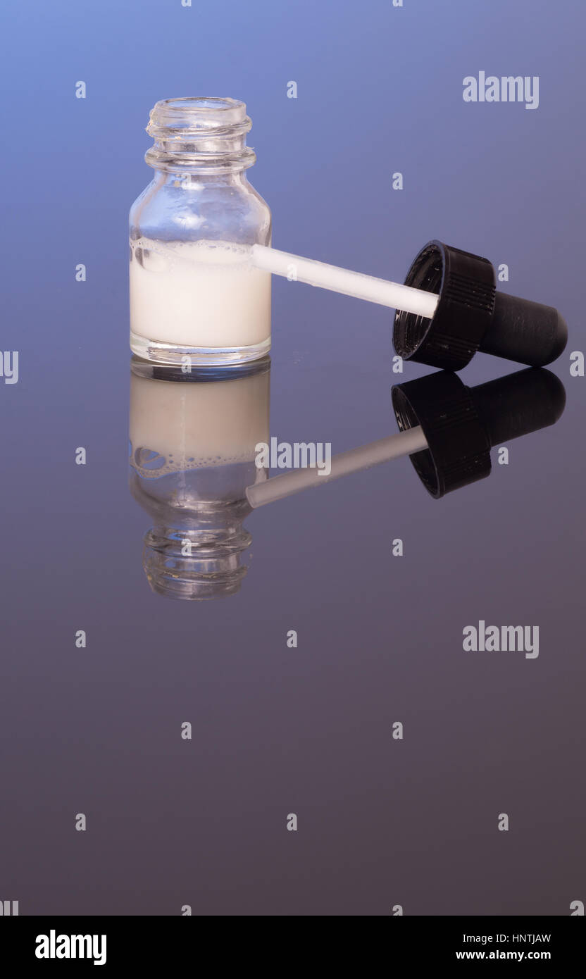 dropper bottle with milk white liquid, isolated Stock Photo Alamy
