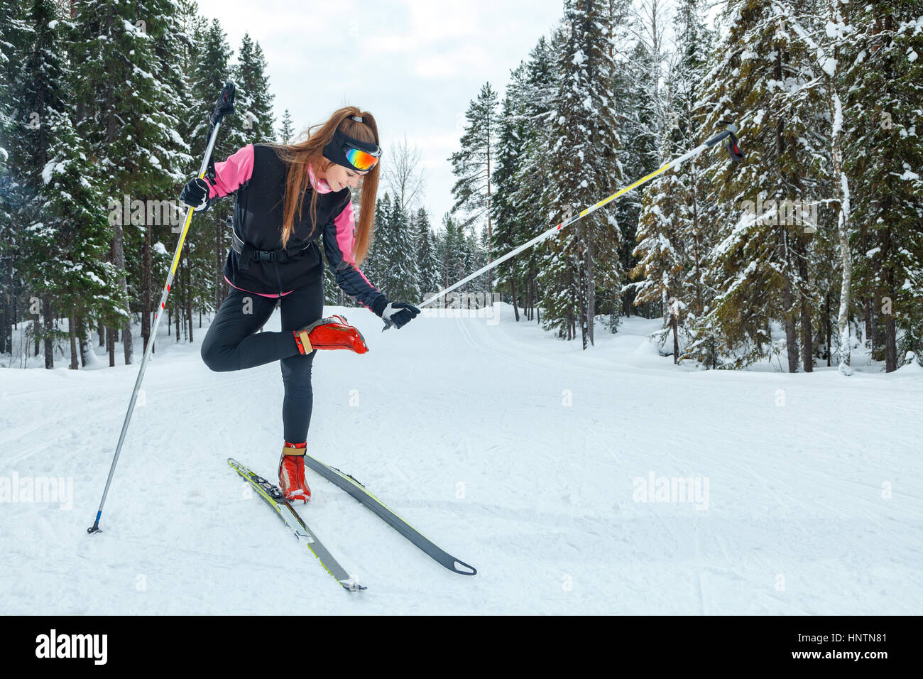 Crosscountry skiing woman doing classic nordic cross country skiing in