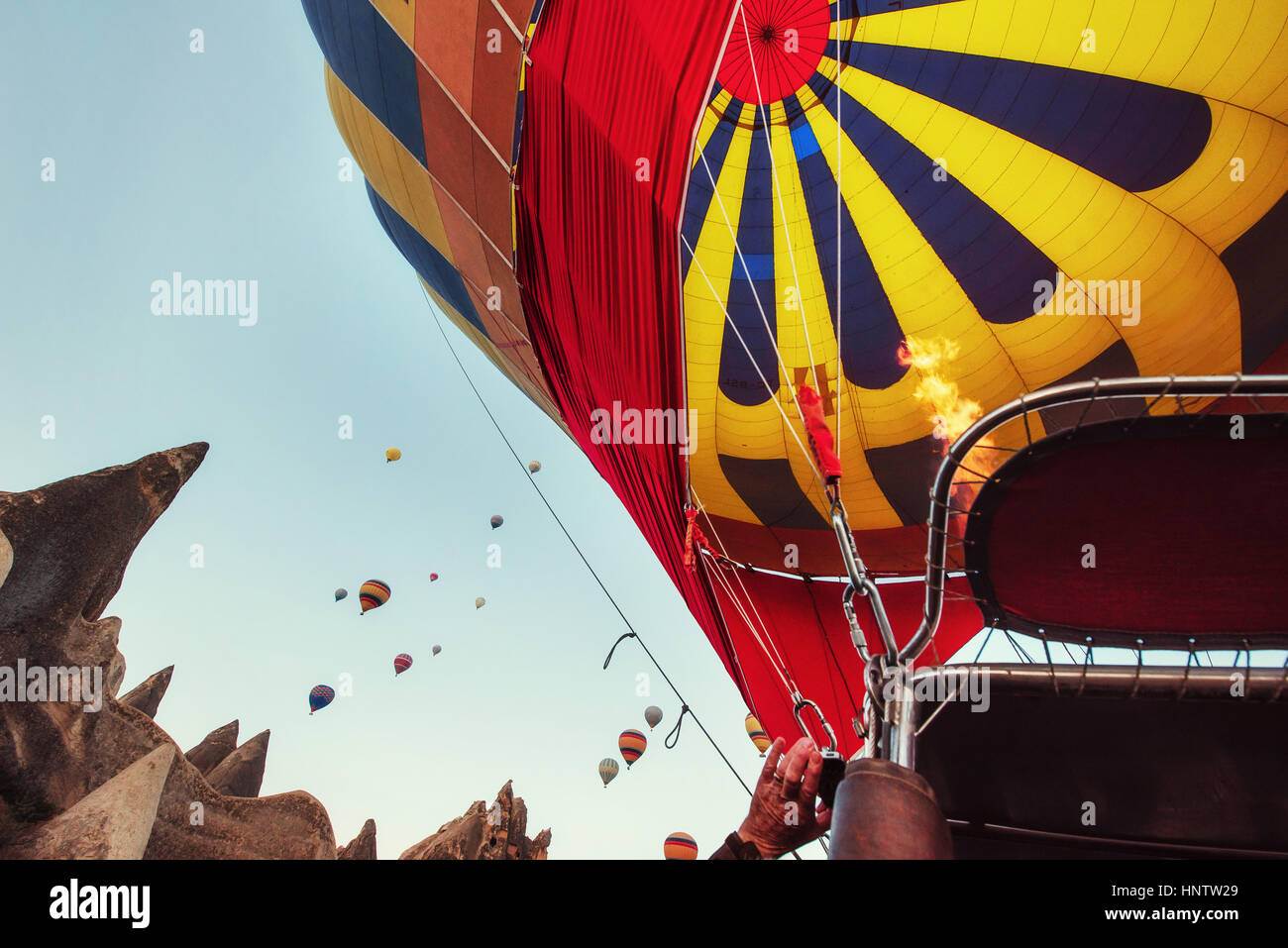 Hot air balloon flying over rock landscape at Cappadocia Turkey Stock ...
