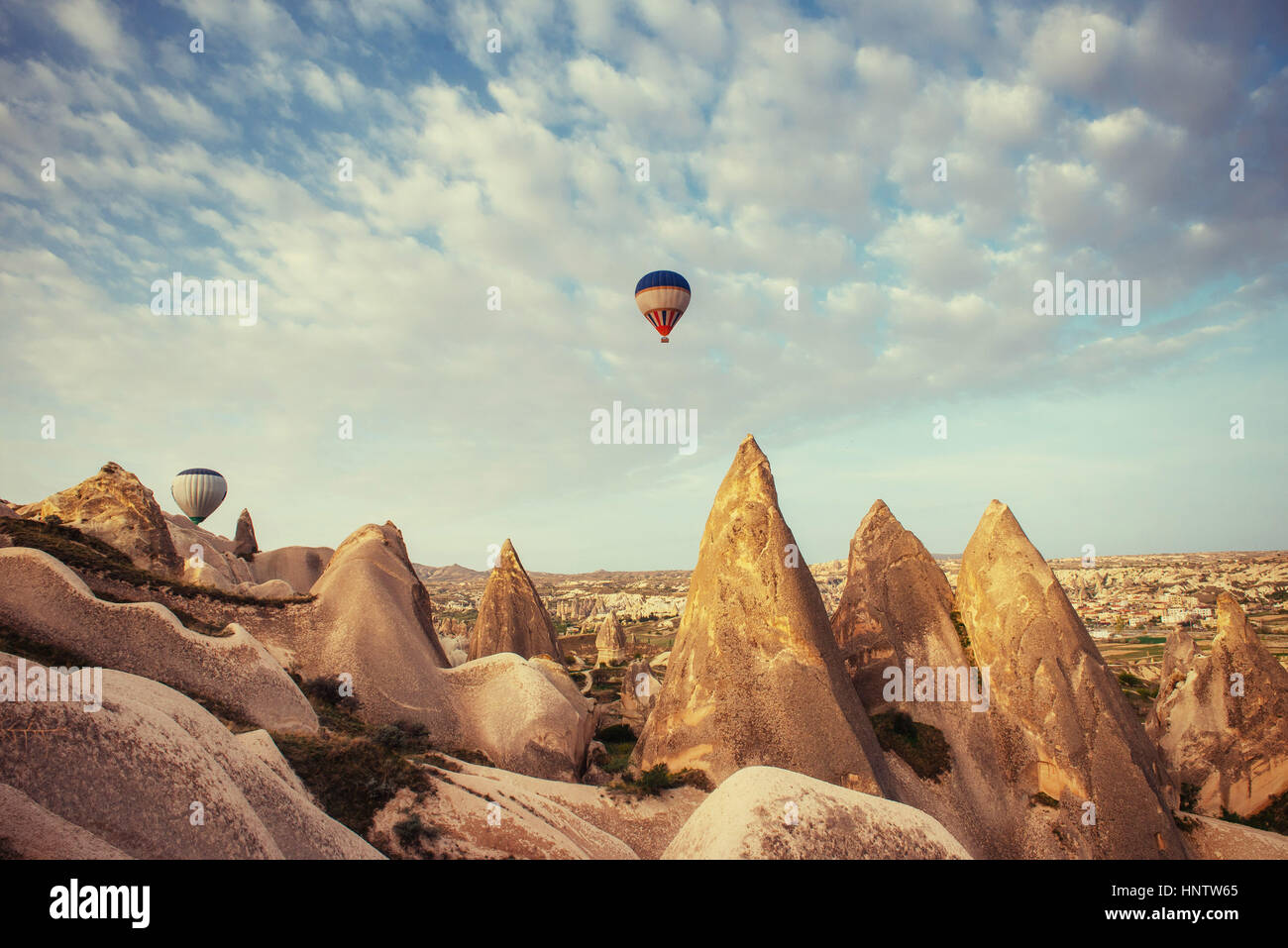Hot air balloon flying over rock landscape at Cappadocia Turkey Stock ...