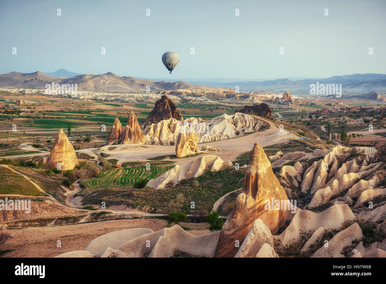 Hot air balloon flying over rock landscape at Cappadocia Turkey Stock ...